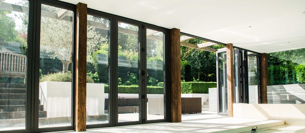 Collection of four insulated travel bottles on wooden shelf.